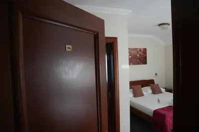 a door to a room with a bed and a bedroom at Comfort Lodge in Stari Banovci