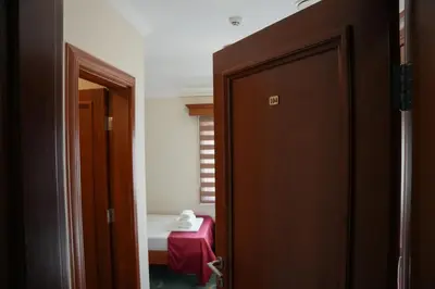 an open door to a room with a red table at Comfort Lodge in Stari Banovci