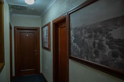 a hallway with a picture of a city on the wall at Comfort Lodge in Stari Banovci