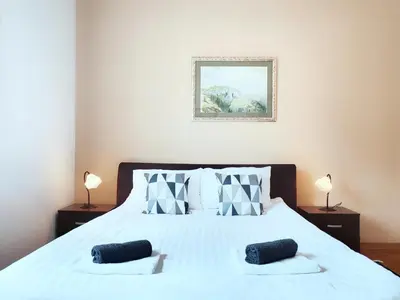 a bedroom with a white bed with two pillows at Parliament City Centre PROMO PRICE in Belgrade