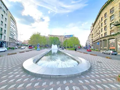 a fountain in the middle of a street with buildings at Parliament City Centre PROMO PRICE in Belgrade
