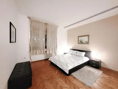 a white bedroom with a bed and a window at Parliament City Centre PROMO PRICE in Belgrade