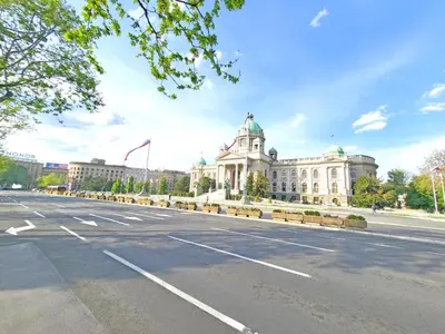 an empty street in front of a large building at Parliament City Centre PROMO PRICE in Belgrade