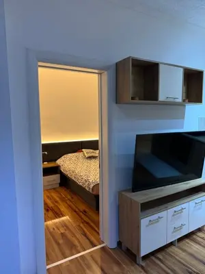 a living room with a tv and a bedroom at VEMA 4 Apartments in Belgrade