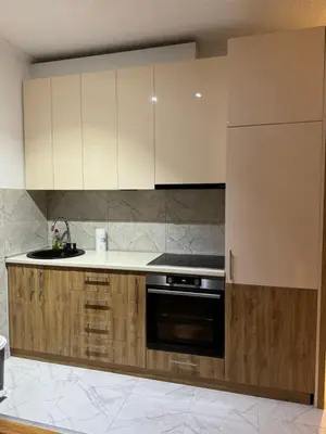 a kitchen with white cabinets and a stove at VEMA 4 Apartments in Belgrade