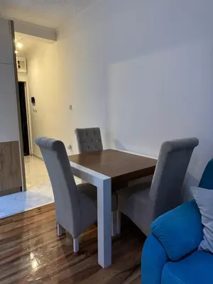 a dining room with a wooden table and chairs at VEMA 4 Apartments in Belgrade