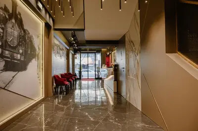 a hallway with red chairs in a building at Lumière Hotel Pool & SPA in Belgrade