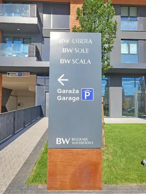a sign in front of a building at Panoramic View Lux Apartment BW in Sajmište