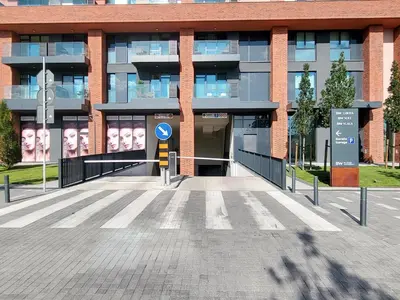 a building with a parking lot in front of it at Panoramic View Lux Apartment BW in Sajmište