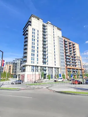 a large white building with cars parked in front of it at Panoramic View Lux Apartment BW in Sajmište