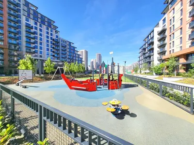 a playground in the middle of a city with buildings at Panoramic View Lux Apartment BW in Sajmište