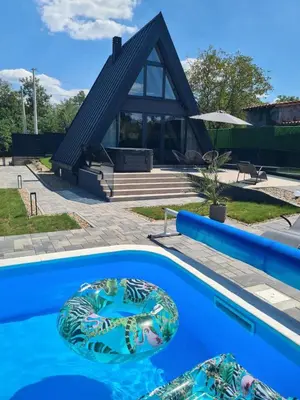 a house with a swimming pool in front of a house at Nikis House Beograd in Ba°evac