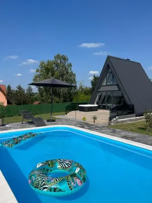 a swimming pool with a house in the background at Nikis House Beograd in Ba°evac