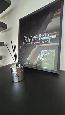 a container with sticks in it sitting on a table next to a mirror at Nikis House Beograd in Ba°evac
