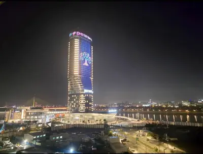 a tall building with a clock on it at night at Panoramic View Premium Apartment BW in Belgrade