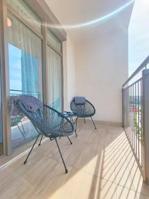 a room with two chairs and a balcony with a view at Panoramic View Premium Apartment BW in Belgrade