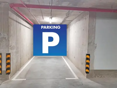 a parking garage with a parking sign on the wall at Panoramic View Premium Apartment BW in Belgrade
