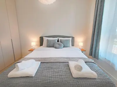 a bedroom with a large bed with two towels on it at Belgrade Waterfront PROMO PRICE in Belgrade
