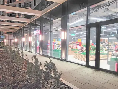 an empty grocery store aisle with glass doors in a store at Belgrade Waterfront PROMO PRICE in Belgrade