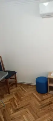 an empty room with a chair and a blue stool at Airpot MD rooms 1 in Belgrade