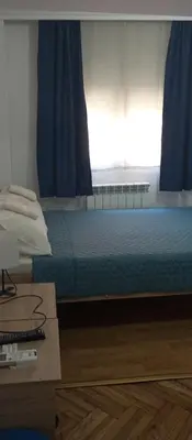 a bedroom with a bed and a desk and a window at Airpot MD rooms 1 in Belgrade