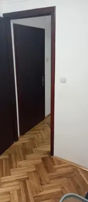 a room with a black door and a wooden floor at Airpot MD rooms 1 in Belgrade