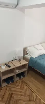 a bedroom with a bed and a table with a lamp at Airpot MD rooms 1 in Belgrade