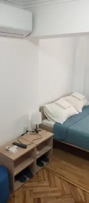 a bedroom with a bed and a table with a lamp at Airpot MD rooms 1 in Belgrade