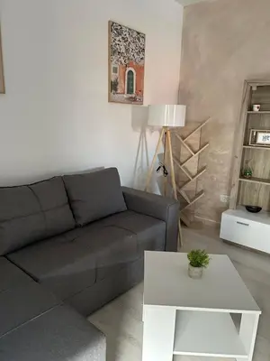 a living room with a couch and a table at Apartman Lola in Novi Grad