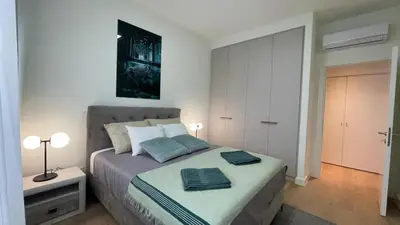 a bedroom with a bed with two towels on it at Scala BW in Sajmište