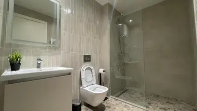 a bathroom with a toilet and a sink and a shower at Scala BW in Sajmište