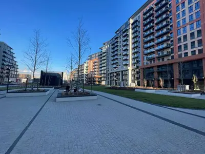 an empty street in a city with tall buildings at Scala BW in Sajmište