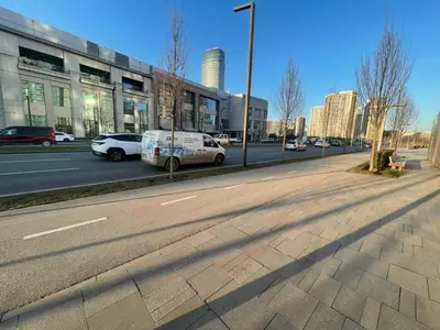 a street with cars parked on the side of the road at Scala BW in Sajmište