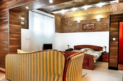 a bedroom with a bed and a table and chairs at Studio 600 in Belgrade