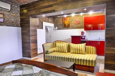 a living room with a couch and a kitchen at Studio 600 in Belgrade