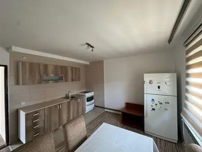 a kitchen with a white refrigerator and wooden cabinets at BIRDS apartmani in Belgrade
