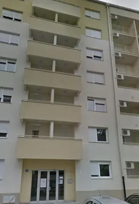 an apartment building with balconies in a parking lot at Boom Spa 1 Belgrade Apartments in Fontana