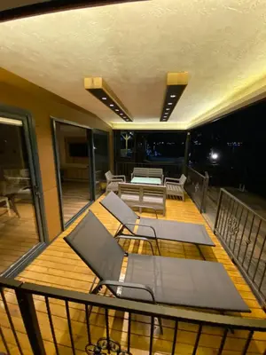 a balcony with a bed and chairs on a deck at Santa Barbara River in Belgrade