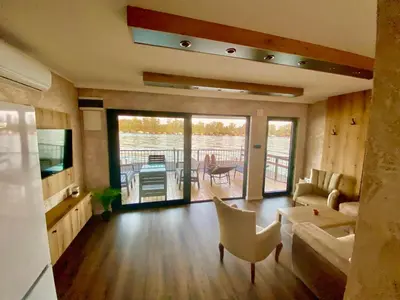 a living room with a couch and a table at Santa Barbara River in Belgrade