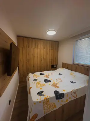 a bedroom with a bed with a comforter on it at Santa Barbara River in Belgrade