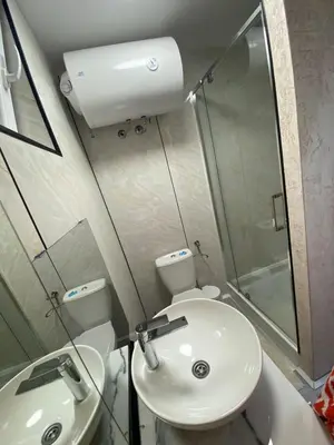 a bathroom with a sink and a toilet and a shower at Santa Barbara River in Belgrade