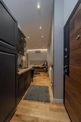 a kitchen with a black refrigerator and a kitchen floor at Rodman Belgrade Apartment in Novi Beograd