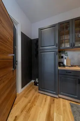 a kitchen with a large gray refrigerator and wooden floors at Rodman Belgrade Apartment in Novi Beograd