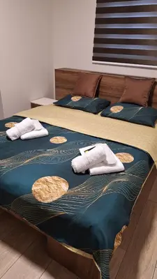 three beds in a room with towels on them at Apartments Green Beograd in Borča