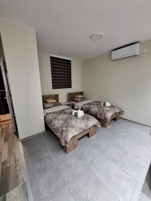 a room with two beds in a room at Apartments Green Beograd in Borča