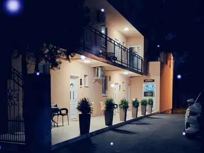 a row of potted plants on the side of a building at Apartments Green Beograd in Borča