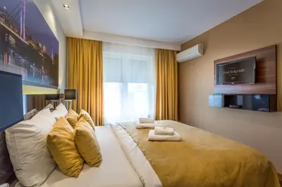 a bedroom with a large bed with towels on it at Feel Belgrade Apartments in Belgrade