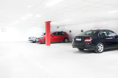 three cars parked in a parking lot at Feel Belgrade Apartments in Belgrade