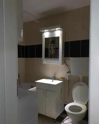 a bathroom with a toilet and a sink and a tub at Stan na dan in Voždovac