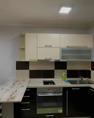 a kitchen with white cabinets and a stove top oven at Stan na dan in Voždovac